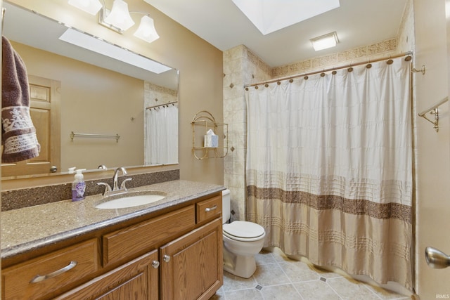 bathroom featuring a skylight, tile patterned flooring, curtained shower, vanity, and toilet