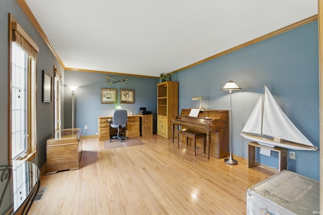 office featuring crown molding, baseboards, wood finished floors, and visible vents