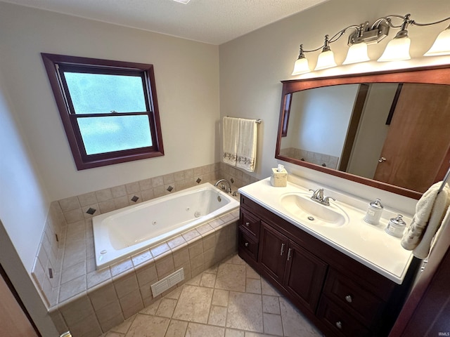 full bath featuring stone finish flooring, visible vents, a tub with jets, and vanity