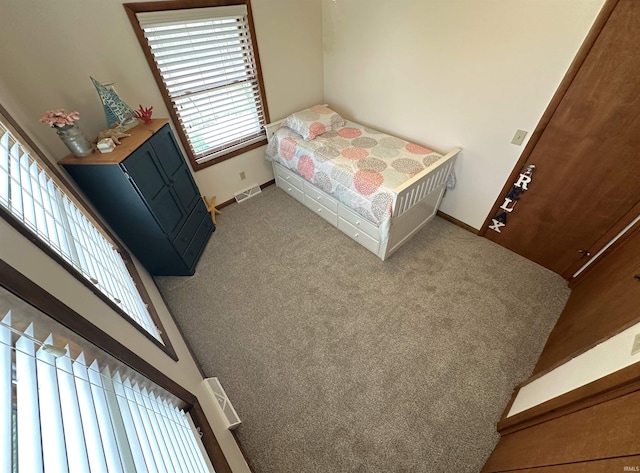bedroom featuring baseboards, carpet, and visible vents