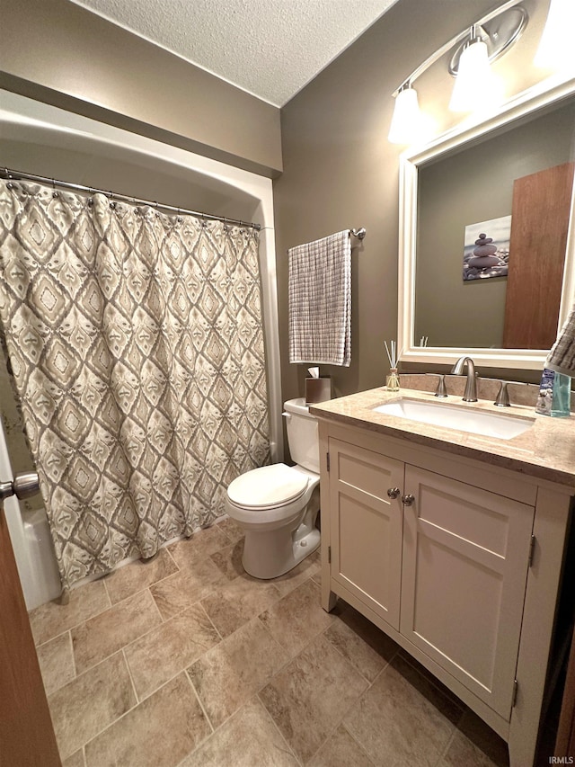 bathroom featuring vanity, a textured ceiling, a shower with shower curtain, and toilet