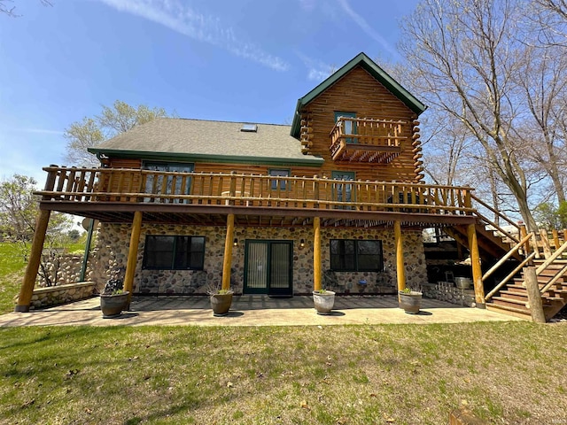 rear view of house with a patio, stairway, a yard, and a deck