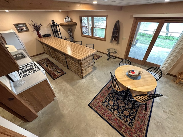 interior space with baseboards, concrete flooring, and recessed lighting