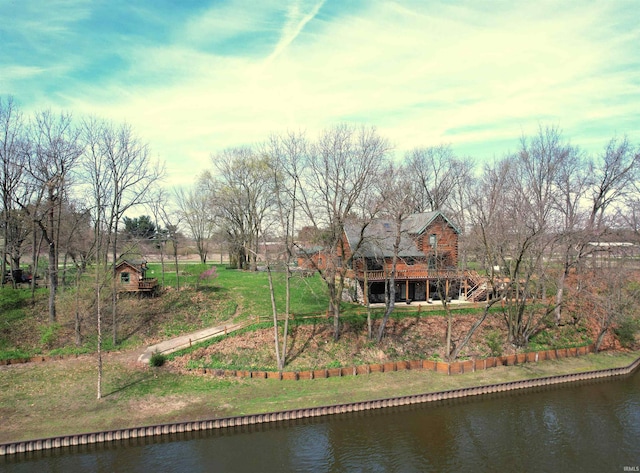 exterior space with a water view and a yard