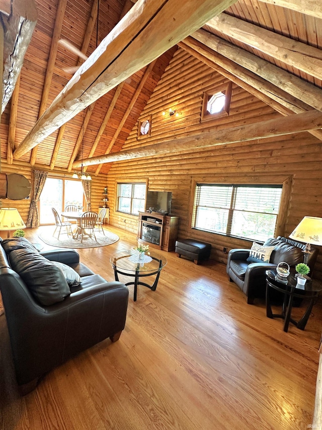living room featuring high vaulted ceiling, a wealth of natural light, wood ceiling, and beam ceiling