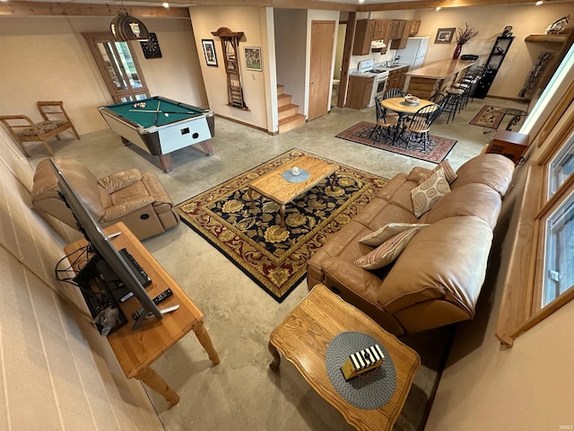 living room with unfinished concrete floors, billiards, and stairway
