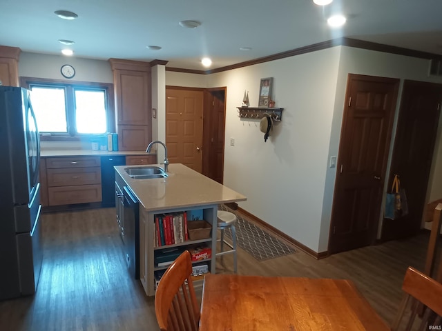 kitchen featuring open shelves, freestanding refrigerator, wood finished floors, light countertops, and a sink
