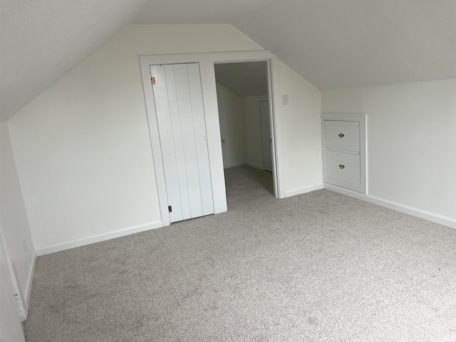1134 N Iowa St, South Bend, IN 46628 - bonus room featuring carpet floors, baseboards, and vaulted ceiling