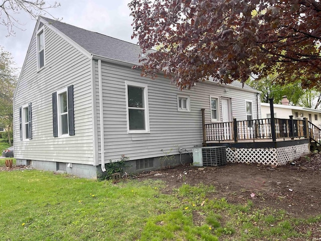 1134 N Iowa St, South Bend, IN 46628 - rear view of property featuring a lawn, roof with shingles, central AC, and a deck