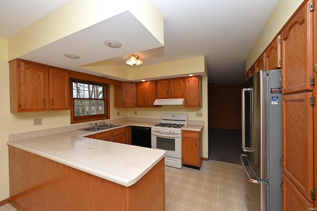 800 E Oak View Est, Winamac, IN 46996 - kitchen with freestanding refrigerator, a peninsula, white gas stove, under cabinet range hood, and dishwasher