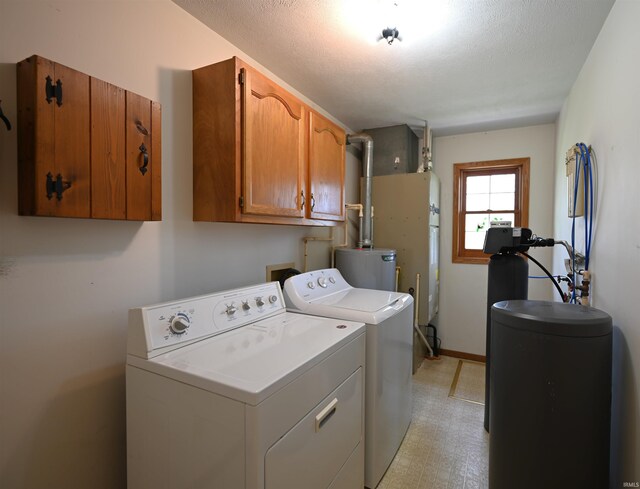 800 E Oak View Est, Winamac, IN 46996 - laundry area with light floors, cabinet space, water heater, and washing machine and clothes dryer