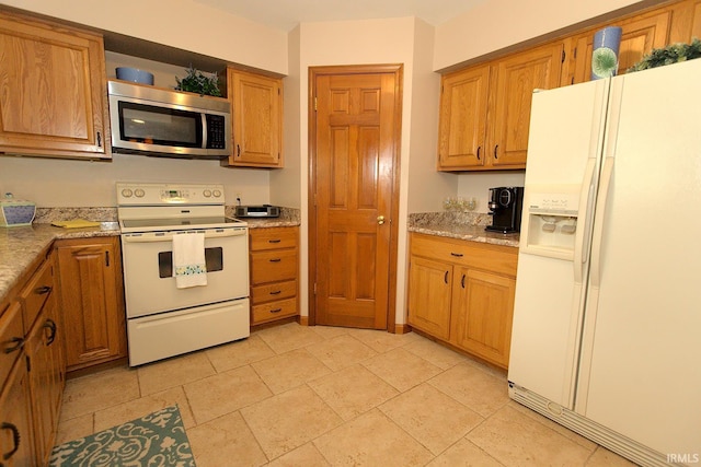 kitchen with brown cabinetry and white appliances