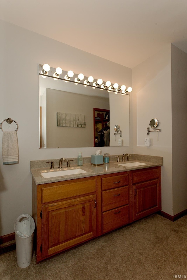bathroom featuring a sink, carpet, and double vanity