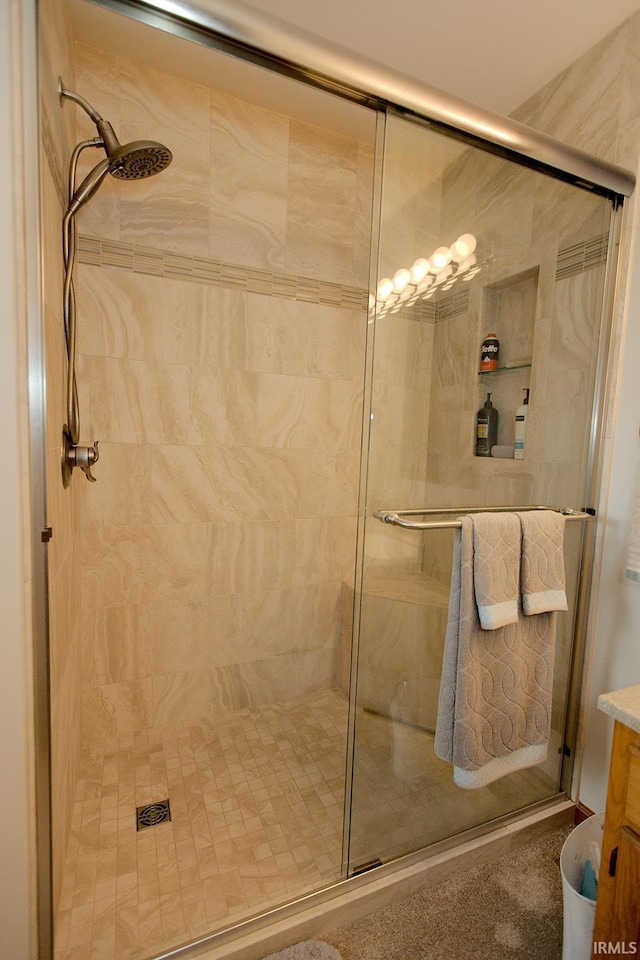 full bathroom with vanity and a shower stall