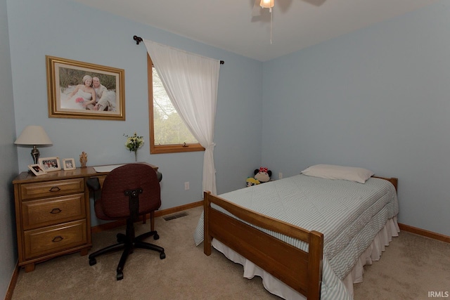 bedroom with light colored carpet, baseboards, visible vents, and a ceiling fan