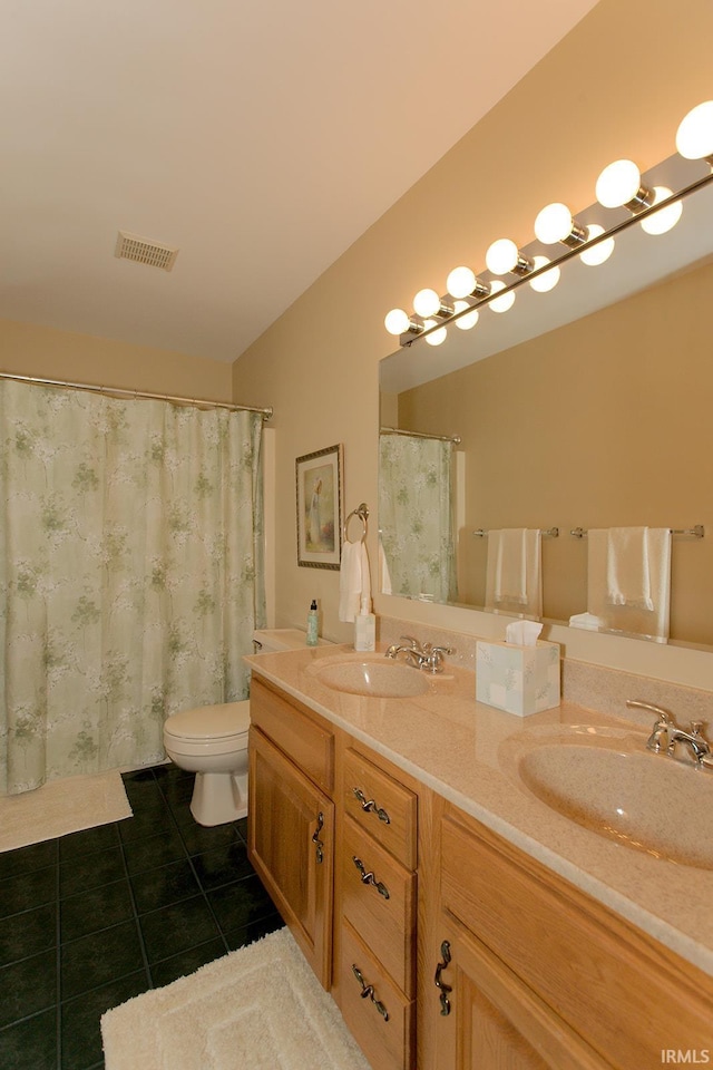 bathroom with tile patterned flooring, a sink, visible vents, and double vanity