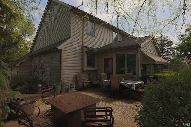 back of house featuring outdoor dining area and a patio area