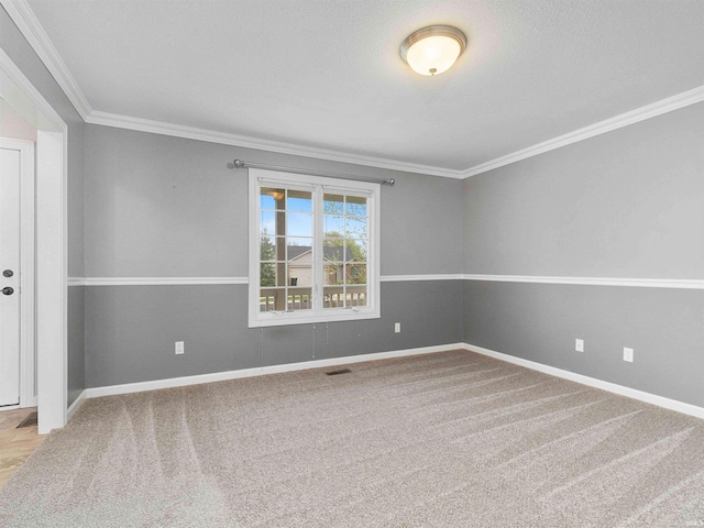 empty room featuring crown molding and baseboards