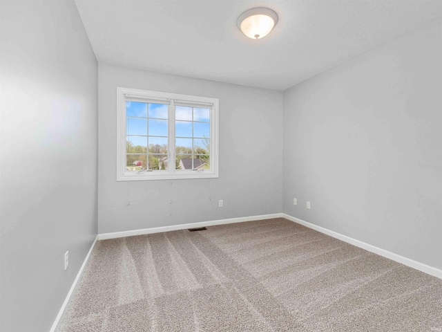 empty room with baseboards and carpet flooring