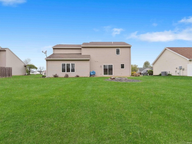 back of property with a yard and cooling unit