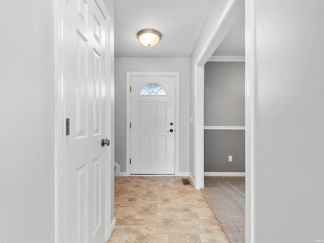 entrance foyer with light wood-style floors, baseboards, and visible vents
