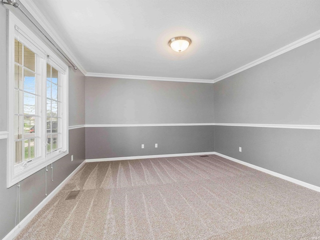 unfurnished room with crown molding, carpet floors, and baseboards