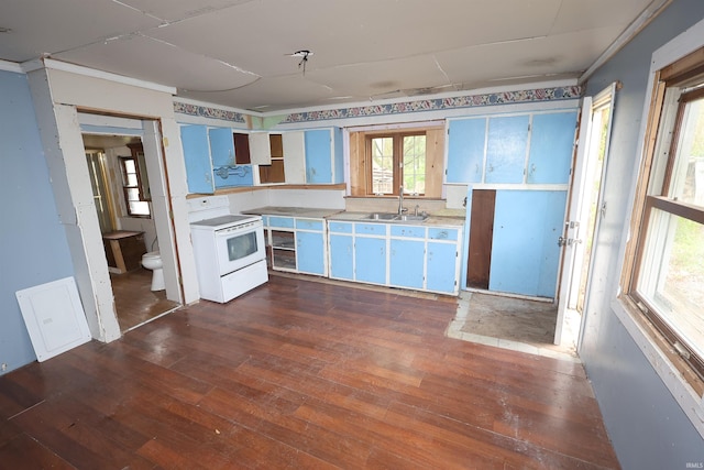 kitchen featuring dark wood-style flooring, electric range, open shelves, a sink, and light countertops