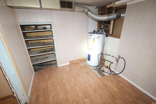utility room featuring visible vents and electric water heater