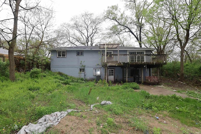back of house with a deck