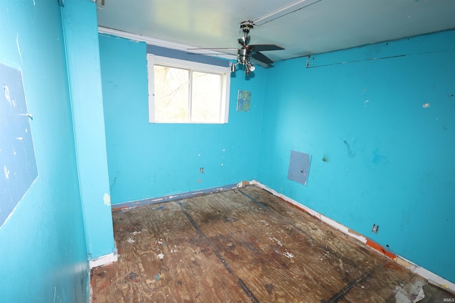 unfurnished room with a ceiling fan and baseboards