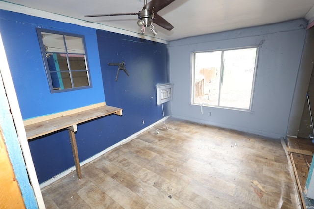 unfurnished bedroom with baseboards, a ceiling fan, and wood finished floors