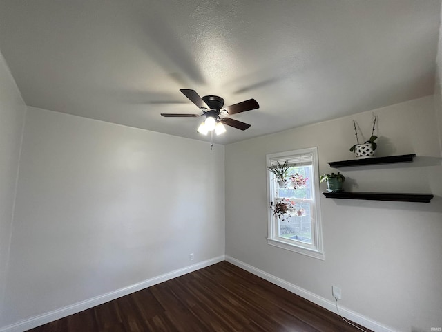 2156 Oakland Ave, Evansville, IN 47711 - unfurnished room featuring baseboards, a ceiling fan, and dark wood-style floors