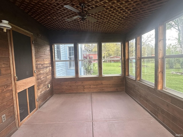 unfurnished sunroom with ceiling fan