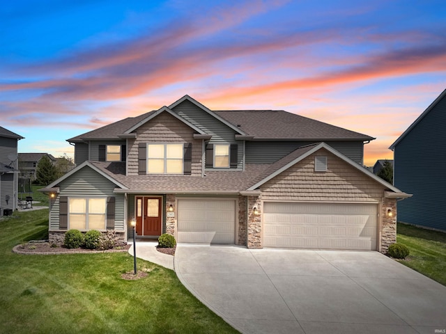 view of front of house with a lawn, driveway, roof with shingles, and stone siding
