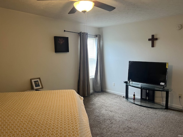 carpeted bedroom with a textured ceiling, baseboards, and a ceiling fan
