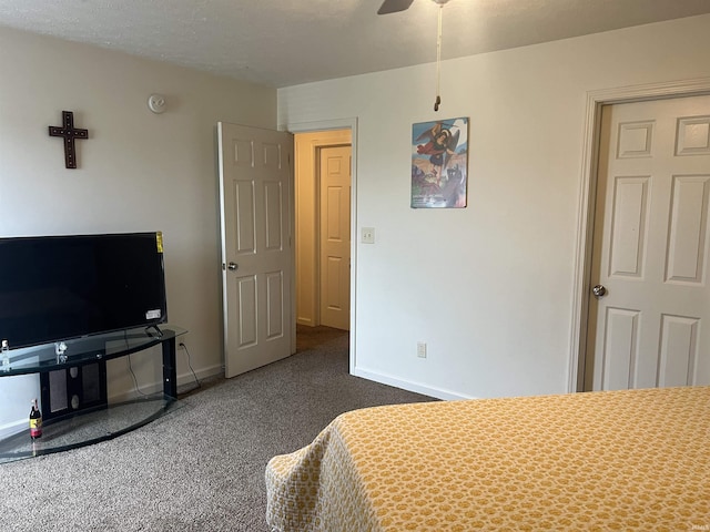 bedroom with dark colored carpet and baseboards