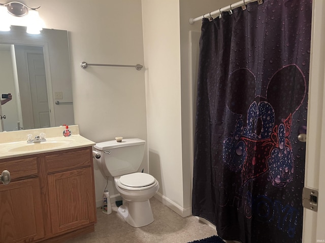 bathroom with vanity, baseboards, toilet, and curtained shower