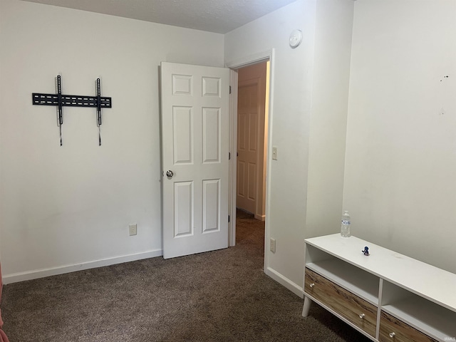 unfurnished bedroom featuring baseboards and carpet flooring