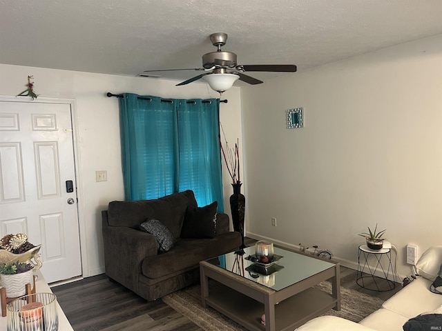 living area featuring ceiling fan, visible vents, baseboards, and dark wood-type flooring