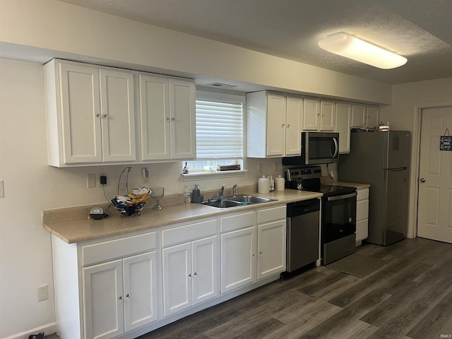 kitchen featuring white cabinetry, dark wood-style floors, and stainless steel appliances
