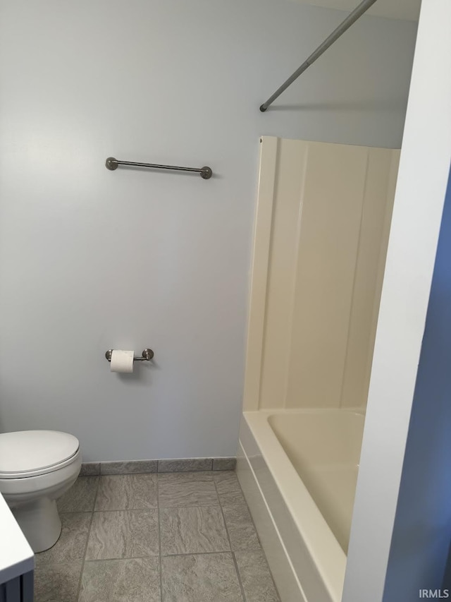 bathroom featuring toilet, baseboards, and vanity