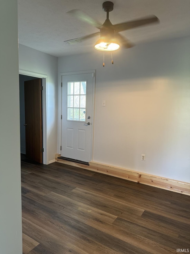 doorway to outside with baseboards, a ceiling fan, and dark wood finished floors