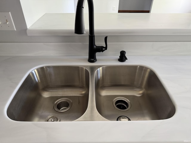 details featuring light countertops and a sink