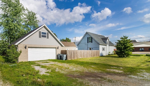view of home's exterior with fence and a lawn