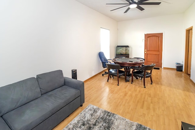 interior space featuring a ceiling fan, baseboards, and light wood-type flooring