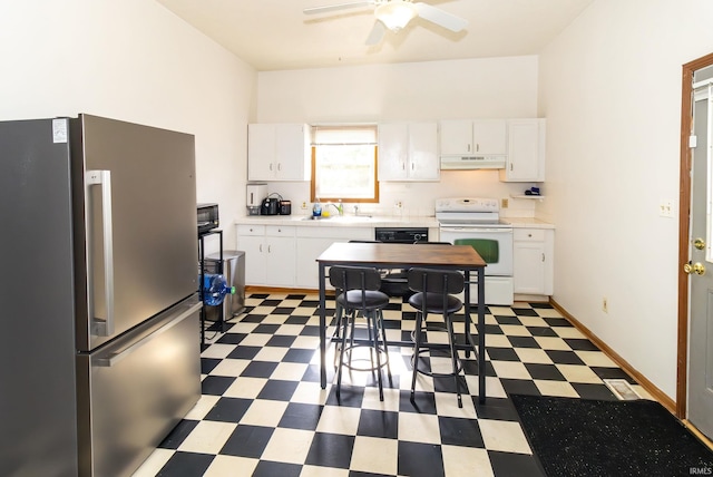 kitchen with freestanding refrigerator, light floors, light countertops, under cabinet range hood, and white range with electric stovetop