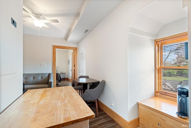 office featuring baseboards, ceiling fan, dark wood-style floors, and visible vents
