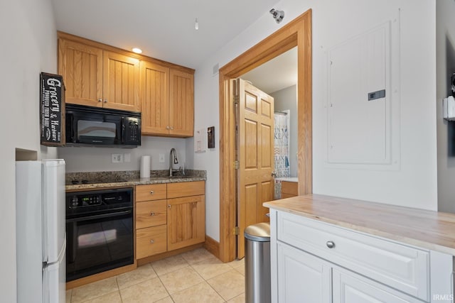 kitchen with light stone countertops, electric panel, a sink, light tile patterned floors, and black appliances