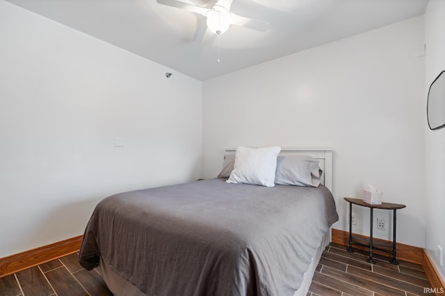 bedroom featuring baseboards, a ceiling fan, and wood finish floors