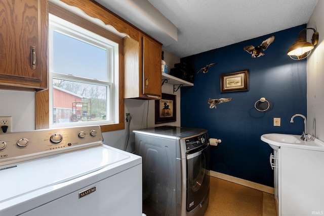 5155 E 200 N, Columbia City, IN 46725 - laundry room featuring a sink, baseboards, cabinet space, and independent washer and dryer